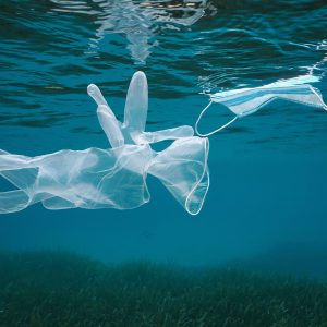 Gloves and face mask underwater in the sea, plastic waste pollution since coronavirus COVID-19 pandemic, Mediterranean sea